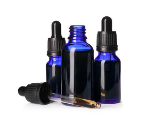 Cosmetic bottles of essential oils on white background