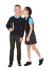 Full length portrait of cute children in school uniform on white background