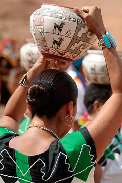 Gallup, New Mexico, USA.  Zuni Olla Maiden walking with a traditional pot on her head