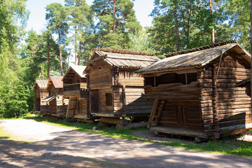 Old authentic traditional wooden buildings from the 17th, 18th, 19th centuries, peasant huts, dwellings in a museum on the island of Seurasaari in Helsinki, Finland, on a sunny summer day. Beautiful F