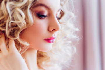 Beautiful portrait with professional makeup for a bachelorette party. Girl blonde with curly hair.
