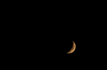 Obraz na płótnie Canvas moon's waxing crescent in July sky
