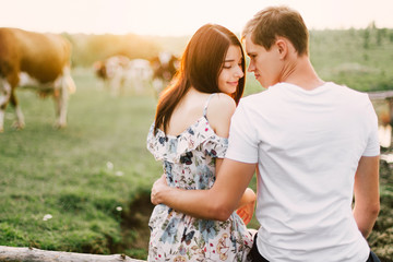 Portrait of happy couple outdoor in nature location at sunset.