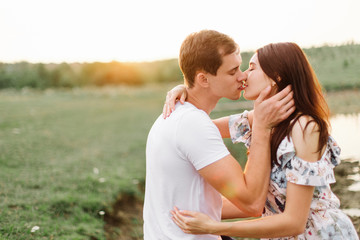 Portrait of happy couple outdoor in nature location at sunset.