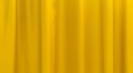 Obraz premium Fabric yellow curtains. Abstract background, curtain, drapes gold fabric. Crumpled cloth, folds of fabric.