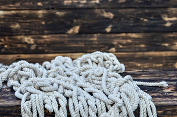 Ship rope on rustic wooden background.  Copy space.