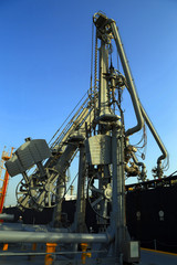 Fototapeta na wymiar Cranes unloading a cargo vessel