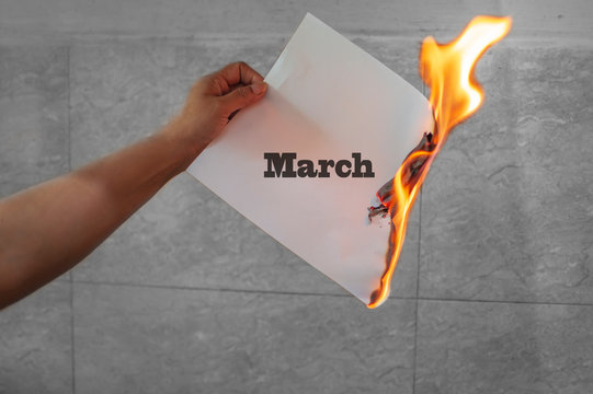 March word text on fire with burning paper