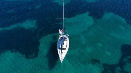 Fototapeta premium Aerial drone birds eye view of sail boat cruising in the emerald Ionian sea, Greece