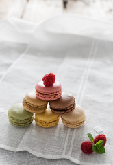 Macarons on white background and rustic wooden table
