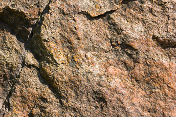 Background of granite. Texture of granite stone. Pattern of roughened surface. Texture of brown stone