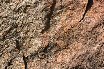 Background of granite. Texture of granite stone. Pattern of roughened surface. Texture of brown stone