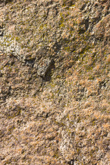 Background of granite. Texture of granite stone. Pattern of roughened surface. Texture of brown stone