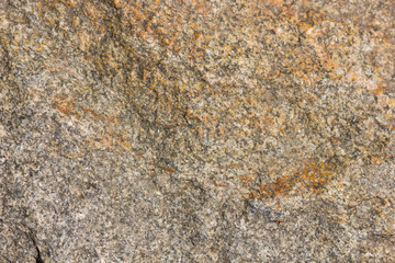 Background of granite. Texture of granite stone. Pattern of roughened surface. Texture of brown stone