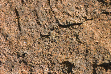 Background of granite. Texture of granite stone. Pattern of roughened surface. Texture of brown stone
