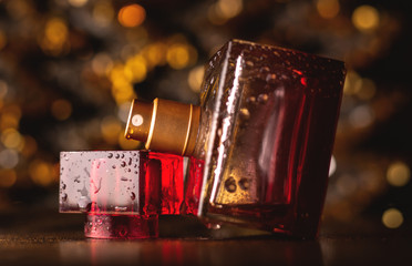 red perfume on golden bokeh background