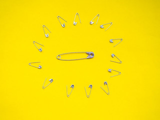 Lots of safety pins making a barrier to fend off greater safety pin. Concept of war