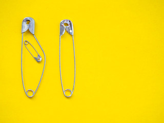 Several safety pins of various sizes in human representation. Concept of traditional family with children