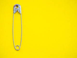 A safety pin representing the concept of loneliness