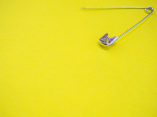 A safety pin representing the concept of loneliness