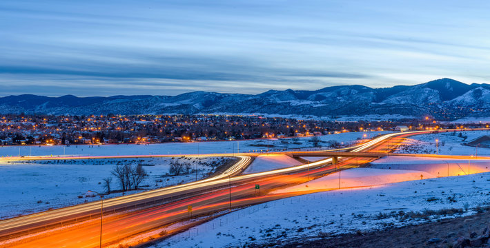 Winter Highway - A panoramic overview of U.S. Highway 285 winding at the foothill of Front Range of Rocky Mountains on a stormy winter evening. Southwest of Denver, Colorado, USA.