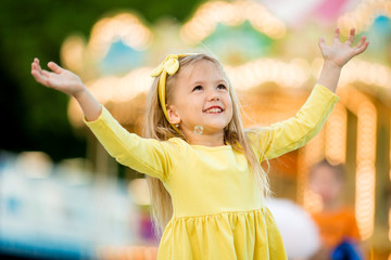 Portrait of baby girl smiling in amusement Park, Happy healthy baby child having fun outdoors on...