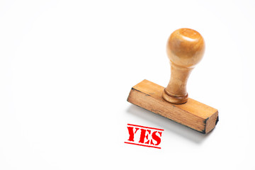 Rubber stamp with yes sign on white background.
