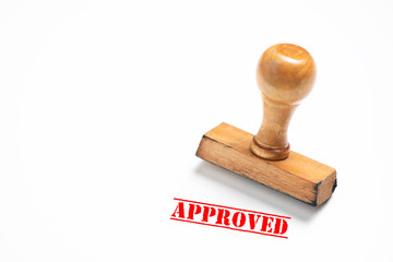 Rubber stamp with approved sign on white background.
