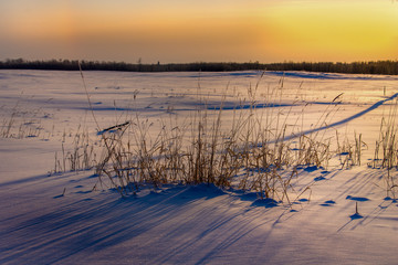 winter sunset over frozen lake