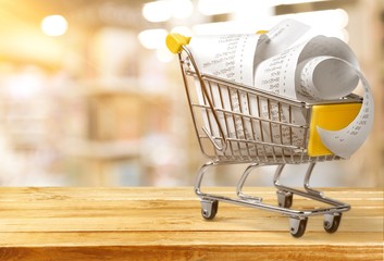 Supermarket check with numbers in shopping cart, close-up view