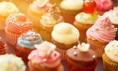Tasty Colorful cupcakes on background