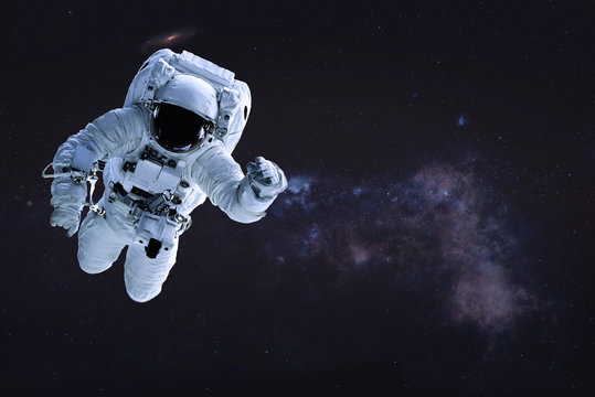Alone single Astronaut in outer space. Science fiction wallpaper. Elements of this image were furnished by NASA.
