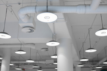 Shopping center led lighting. Ceiling lights in the mall. Ventilation and water pipes. Fire alarm system - 268242234