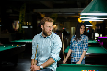 Happy couple playing snooker together