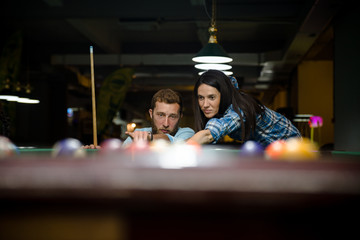 Happy couple playing snooker together