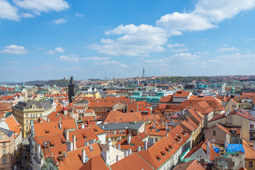 Naklejka premium Aerial panoramic top view above old town and city skyline with famous attraction; The Powder and Henry's Tower and Television Tower against blue sky on sunny day in summer in Prague, Czech Republic.