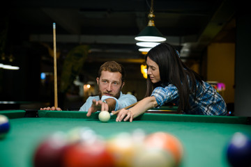 Fototapeta premium Happy couple playing snooker together