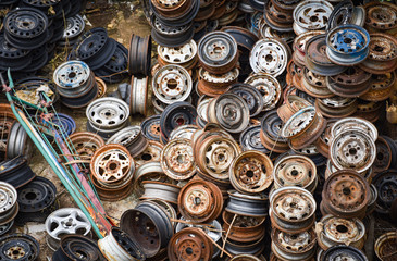 scrap metal / heap of old rusty metal wheel rims in the car dum wheel vehicle waste