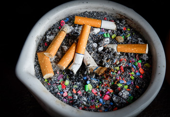 cigarette stub on ashtray in the smoking area
