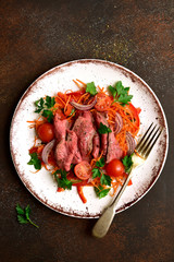 Vegetable salad with roast beef. Top view with copy space.