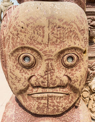 a head sculpture with money in it´s eyes