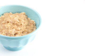 Oatmeal in a Blue Bowl on a White Background