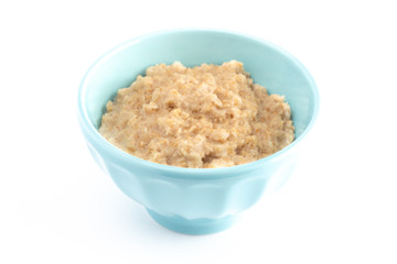 Oatmeal in a Blue Bowl on a White Background