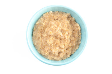 Oatmeal in a Blue Bowl on a White Background