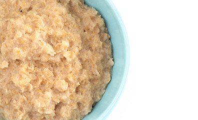 Oatmeal in a Blue Bowl on a White Background