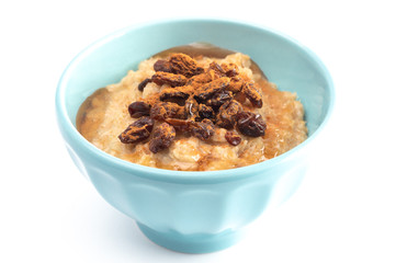 Cinnamon Raisin Oatmeal in a Blue Bowl on a White Background