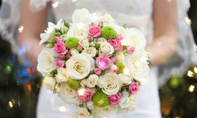 Bride with beautiful wedding bouquet on background