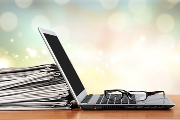 Laptop and black glasses  on   background.
