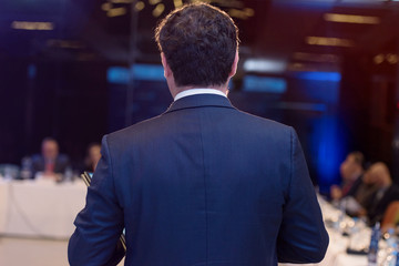 Young businessman at business conference room with public giving presentations. Audience at the conference hall. Entrepreneurship club.