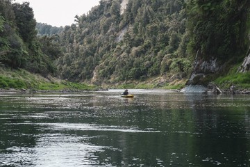 Man paddling on a kayak on a river